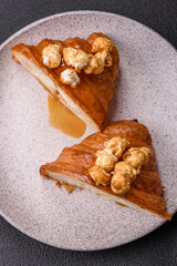 Sweet crispy croissant with salted caramel and glazed popcorn