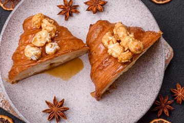 Sweet crispy croissant with salted caramel and glazed popcorn