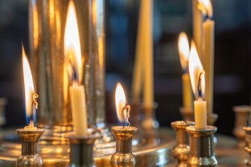 Burning candles in Christian church. Blessed wax candles burning in the basilica..
