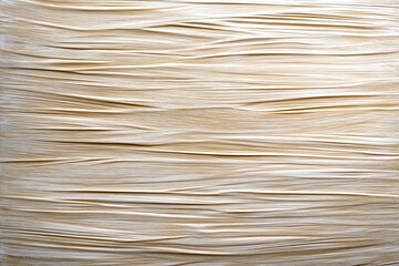 A brushed metal surface, with subtle horizontal lines and a soft metallic sheen
