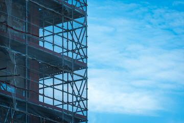 Scaffold sheeting net wrapped apartments building during insulation in england uk