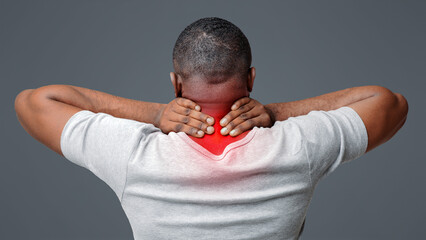 Afro guy suffering from pain in neck. Symptom of cervical chondrosis. Inflammation of vertebra,...