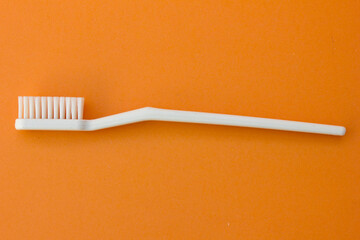 The photograph highlights the texture and form of a toothbrush’s bristles and handle, providing a...