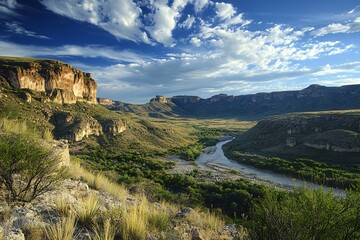 Naklejka premium Scenic View of a River Winding Through a Mountain Valley