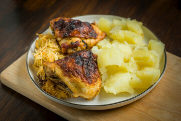 homemade dinner - baked chicken drumsticks with cabbage and potatoes