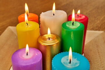 Lit candles of various colors creating a warm atmosphere