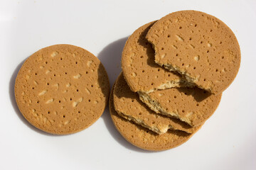 A stack of Indonesia biscuits in a white plate, with a soft and tasty milky flavor for a luxurious bite.