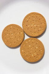 Soft-baked circle biscuits with soft texture, a delightful snacks on the white plate. Perfect for your afternoon tea time.