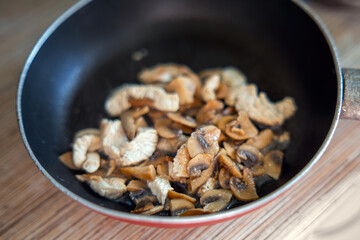 tantalizing dish of sauteed champignon mushrooms and succulent turkey meat on a petite skillet,...