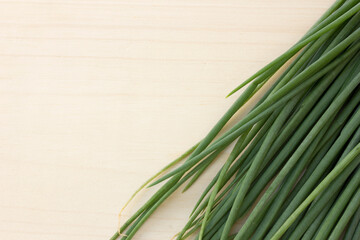 Highlight the vibrant green color of chives against a clean white backdrop. This description...