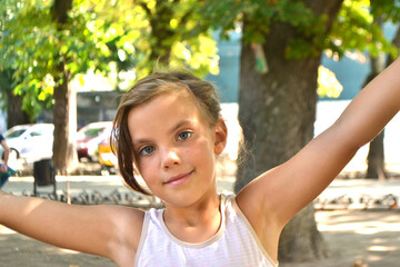 Cute kid girl 10 year old posing on nature background. Looking at camera. Childhood.Blonde girl...