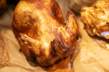 Close up of a perfectly roasted chicken on a piece of paper