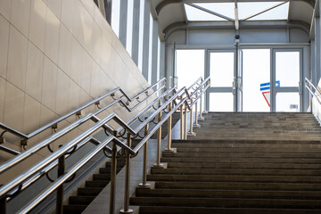 A beautiful set of stairs featuring a sleek stainless steel railing