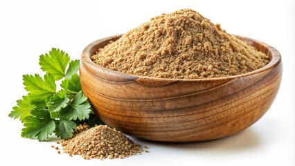 Coriander powder in a wooden bowl with fresh coriander leaves beside it on a white background
