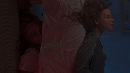 Woman sitting on the bed in dark apartment room, falls on the bed, creepy monster girl laying down...