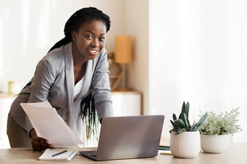 Paperwork. Millennial African American Businesswoman Working With Documentation And Laptop In Modern Office, Free Space