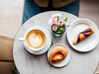 Coffee cup and donut on wooden table, top view