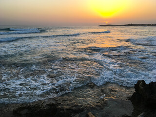 Naklejka premium Sunset in Cyprus. View of coast at sunset. Promenade of the Mediterranean sea. Evening landscape of Cyprus.