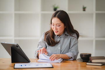 Focused Female Entrepreneur Analyzes Financial Reports at Home Office 