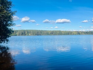 beautiful blue lake view, blue sky with white clouds reflections on the lake surface