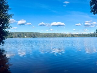 beautiful blue lake view, blue sky with white clouds reflections on the lake surface