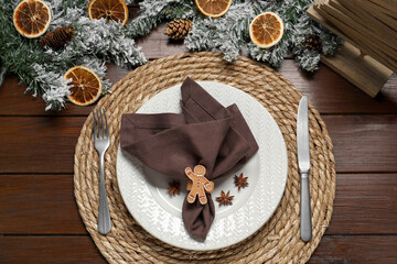 Christmas place setting with festive decor on wooden table, flat lay