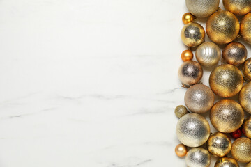 Different Christmas balls on white marble background, flat lay. Space for text