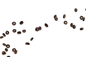 Chocolate rings cereal spill out into a bowl. Breakfast.