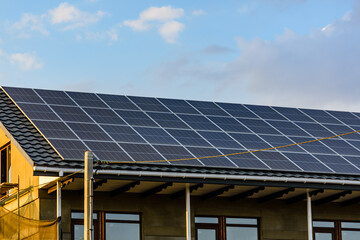 Naklejka premium Solar panels on roof of residential house. Clean energy. Ecological concept
