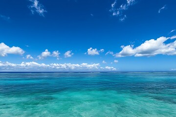 Fototapeta premium Clear blue ocean water with a white cloud sky. Tropical vacation paradise summer holiday