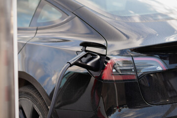 Plugged in electric car at EV charging station