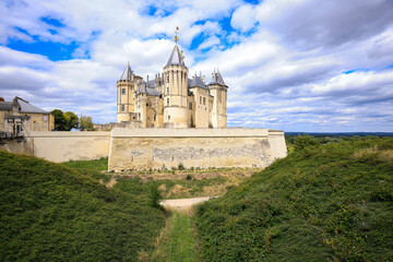 Castle Saumur, France, located at the Loire river under a beautiful sunny cloudscape during daytime.