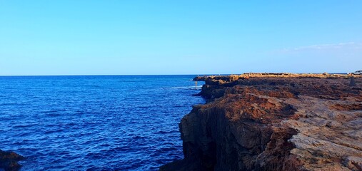 
Panorama of the Mediterranean Sea in Spain with a view of the rocks, lighthouse, tourists walking on the observation deck. Sea coast, sea cliffs, excursion Mediterranean Sea, relaxation, beach.