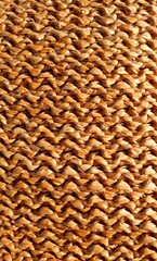 Wicker texture. Wicker brown background. Interior design wicker. Brown wicker ornament made from natural materials. Knitted ornament beige color.