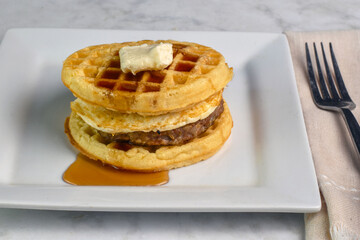 fried egg and sausage patty  between waffles
