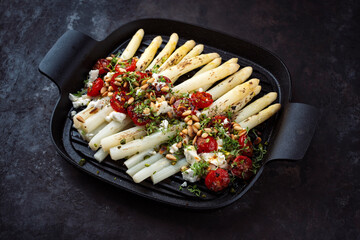 White asparagus caramelized with Greek feta cheese, tomatoes and roasted pine nuts served as...