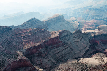The Grand Canyon's vast detail landscape stretches out in layers of red, orange, and brown rock, carved by the Colorado River over millions of years.