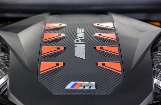 BMW XM engine - hybrid, plug-in V8 engine. Engine motor M POWER of BMW XM 50e close-up with emblem. BMW sport engine or motor under vehicle hood.