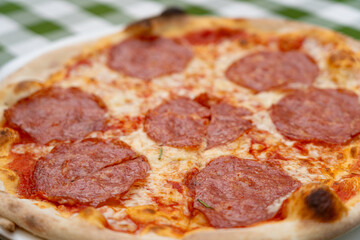 Pepperoni Pizza on Restaurant Plate, Macro Salami Pizza with Tomatoes and Mozzarella Cheese Texture, Selective Focus