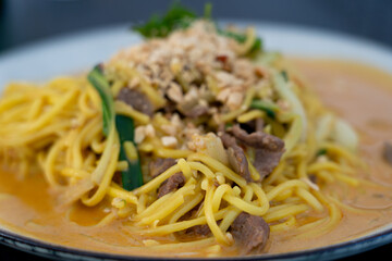 Chiang mai curry noodles, asian spicy egg pasta with meat, curried noodle soup Khao Soi or Khao Sawy, thai food