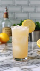Refreshing lemon drink with ice and fresh lemons on counter