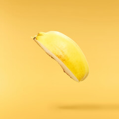 Fresh ripe yellow Quince fruit  falling in the air isolated on yellow background. Food levitation...