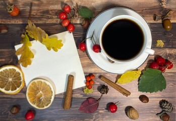 Cozy autumn photo with a cup of coffee, flashlight, crocheting, leaves and autumn decor