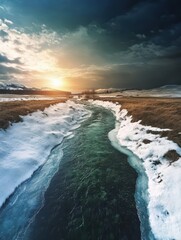 Fototapeta premium Serene River Running Through a Snowy Landscape at Dusk