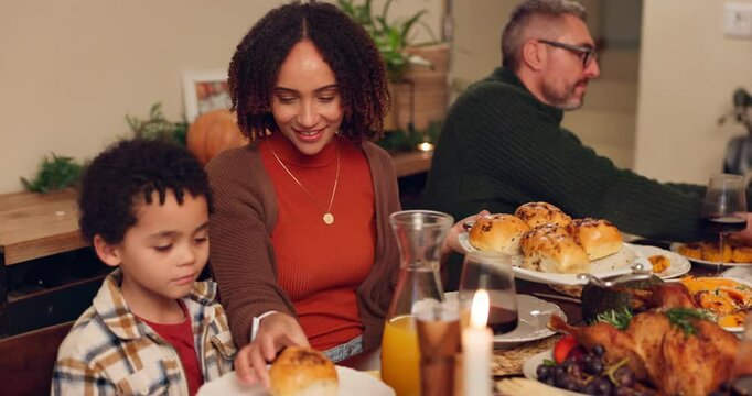 Happy interracial family, dining and food with table for thanksgiving dinner, meal or supper together at home. Mother, father and child with bread for feast, serving or eating in celebration at house