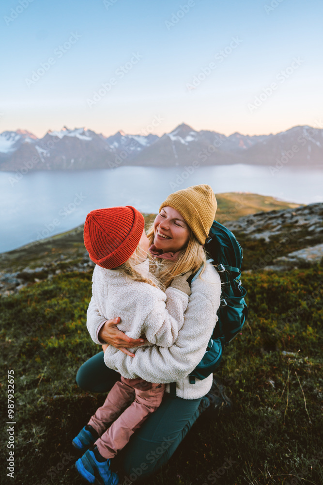 Poster mother hugging child hiking in mountains family having fun together travel lifestyle outdoor active 