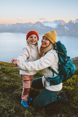 Mother playing with child in mountains family mom and daughter having fun outdoor hiking...