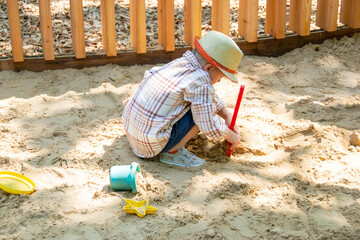 Child on playground in summer park. High quality photo