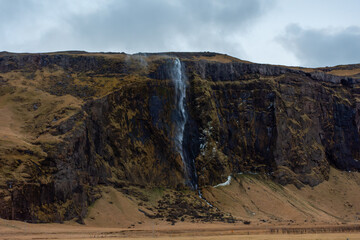 Waterfall flowing from a rock in  Iceland