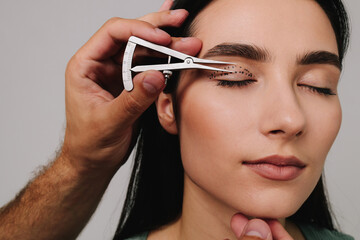 Preparing for blepharoplasty to correct droopy eye lids. Upper blepharoplasty. Plastic surgeon is...